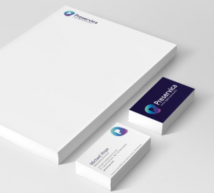 White stationery set with business cards. Visible text includes 