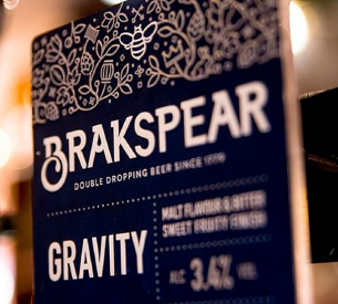 Blue beer label with decorative top border. Text: 