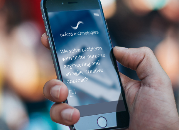 Oxford Technologies website displayed on a smartphone, showing the tagline 'We solve problems with fit-for-purpose engineering and an agile, creative approach.'