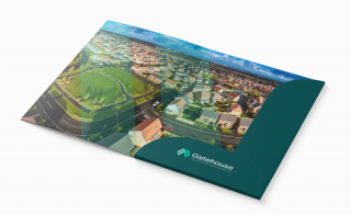 Aerial view of suburban neighborhood brochure. Visible text: 